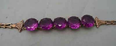 Lot 222 - An Egyptian bracelet set with five graduated simulated Alexandrite stones (probably synthetic...