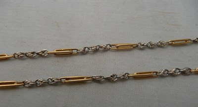 Lot 232 - A fancy link albert chain with alternating yellow trombone links and white twist links, with swivel