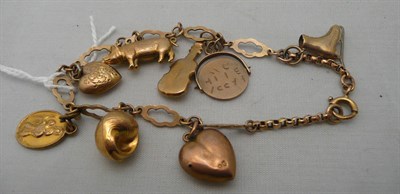 Lot 245 - A 9ct gold charm bracelet hung with eight charms