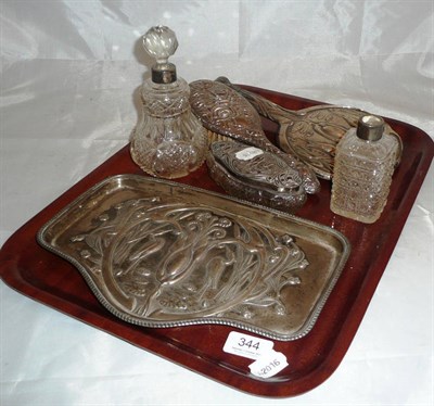 Lot 344 - Silver dressing table tray embossed with a stork, two matching dressing table items, silver mounted