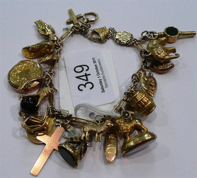 Lot 349 - A charm bracelet hung with twenty five charms