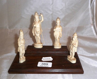 Lot 389 - Four Nepalese ivory deities on a rosewood base