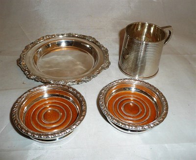 Lot 403 - A silver christening mug, a pair of plated wine coasters and a bottle coaster