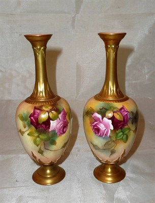 Lot 453 - A pair of Royal Worcester porcelain pedestal ovoid vases, shape 281, each painted with roses,...