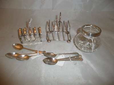 Lot 460 - Two silver toast racks, silver teaspoons and a silver-mounted glass jar