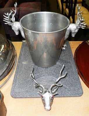 Lot 483 - A champagne bucket with stag head handles and a similar carving set