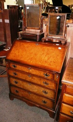 Lot 638 - A walnut reproduction bureau and two Victorian mahogany toilet mirrors