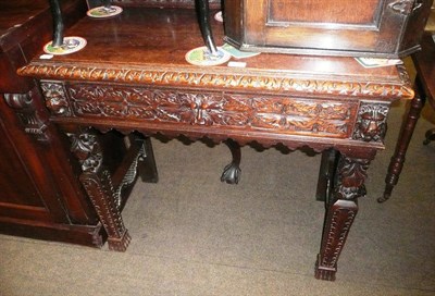 Lot 651 - A Victorian carved oak side table