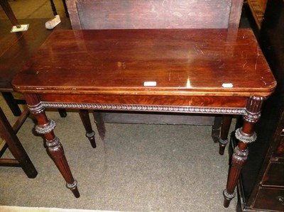 Lot 671 - A mahogany foldover tea table, late 19th century, the hinged top above a plain frieze and egg...