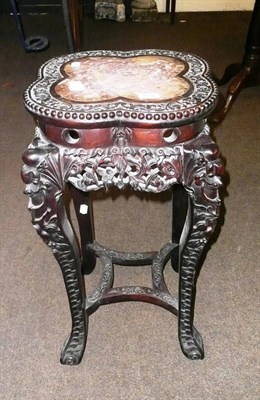 Lot 678 - A carved Chinese hardwood plant stand with marble top