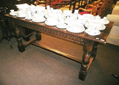 Lot 680 - A carved refectory table on stretcher base