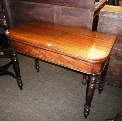 Lot 682 - An early 19th century mahogany D-shape fold-over side table raised on turned and tapered legs...