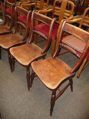 Lot 697 - A set of four country chairs with elm seats and rope backs