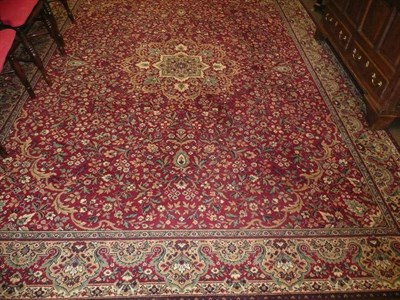 Lot 719 - A red ground patterned carpet