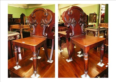 Lot 720 - A pair of early Victorian mahogany hall chairs