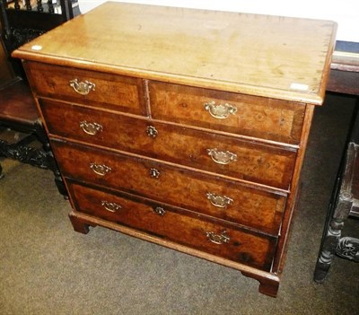 Lot 782 - A walnut chest of two short and three long graduated drawers (later oak top)