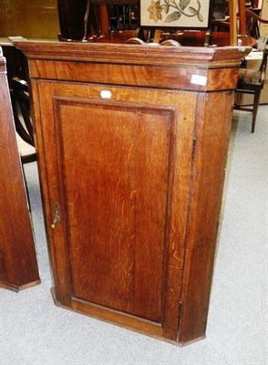 Lot 838 - A Georgian oak and mahogany cross-banded corner cabinet