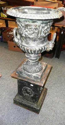 Lot 937 - A cast two-handled pedestal urn on stand