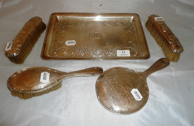 Lot 11 - A silver dressing table tray and a four piece non matched brush set