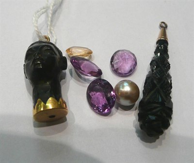 Lot 90 - A Blackamoor pendant, a carved French jet pendant, three amethyst stones, a citrine stone and a...