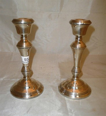 Lot 93 - Pair of loaded silver candlesticks