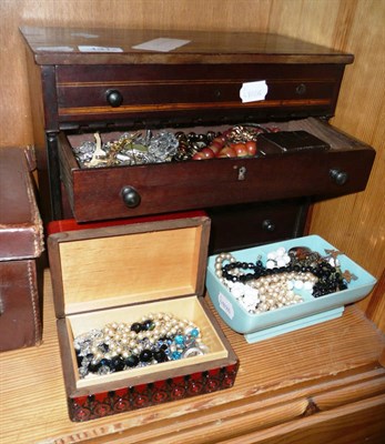 Lot 131 - A quantity of costume jewellery including brooches, earrings etc in a small chest and two boxes