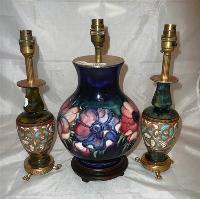 Lot 167 - A Moorcroft table lamp and a pair of Doulton vases as lamps