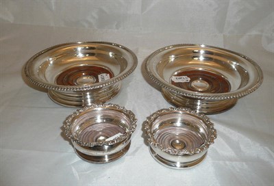 Lot 170 - A pair of large silver plated bottle coasters and two smaller (4)