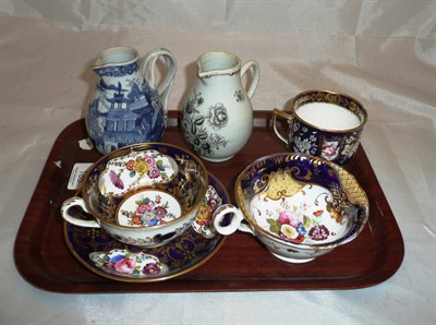 Lot 185 - Rockingham cup and saucer, two English blue group cups and two 18th century jugs