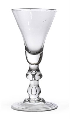 Lot 1 - A Baluster Wine Glass, circa 1720, the large thistle bowl on a drop knop and baluster stem with air