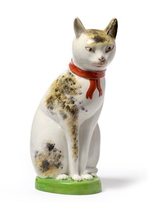 Lot 8 - A Yorkshire Pottery Figure of a Cat, circa 1810, the seated animal with sponged ochre and black...