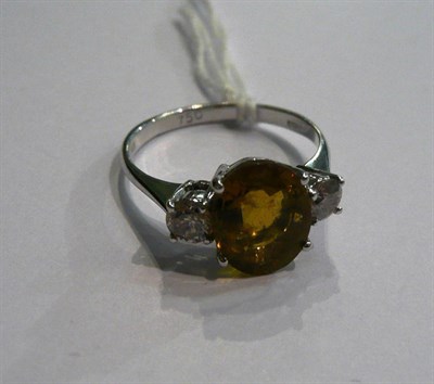 Lot 13 - An 18ct white gold tourmaline and diamond three stone ring