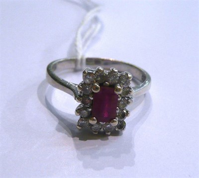 Lot 22 - A 9ct white gold ruby and diamond cluster ring