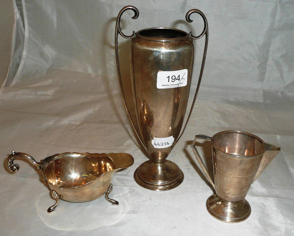 Lot 194 - Tall silver two handled vase, cream jug and sauce boat