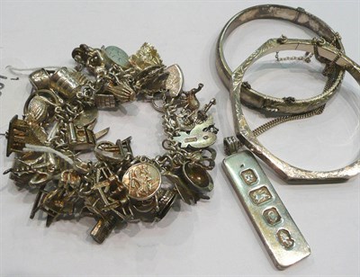 Lot 227 - Silver charm bracelet and two bangles