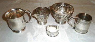 Lot 248 - A silver cream jug, a sugar bowl, and two mugs and a silver napkin ring