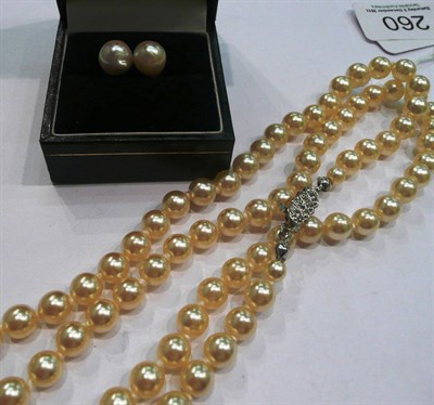 Lot 260 - A single strand of simulated pearls and a pair of cultured pearl earrings