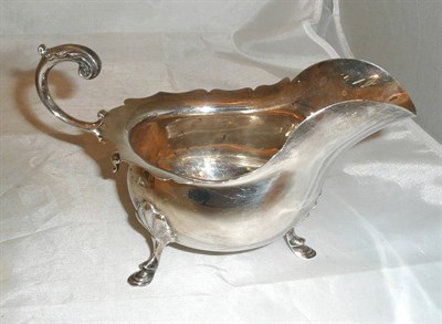 Lot 277 - A silver tripod sauce boat, Walker & Hall, Sheffield, 9oz