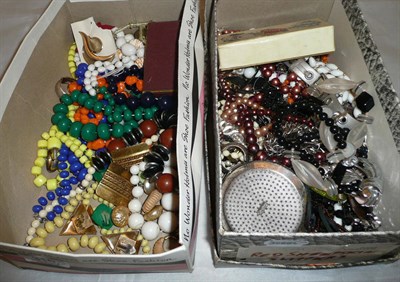 Lot 316 - Two boxes of costume jewellery including bead necklaces, a trifari brooch, a compact, brooches,...