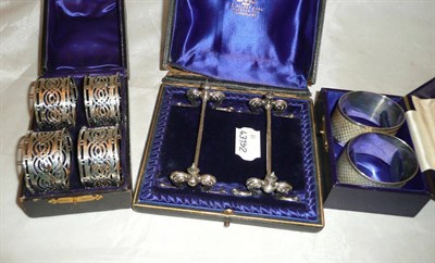 Lot 317 - Four napkins rings, cased and a pair of napkin rings and a pair of knife rests