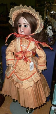 Lot 355 - A bisque socket head SFBJ doll, impressed 60 with a modern brown wig, fixed brown eyes, open...