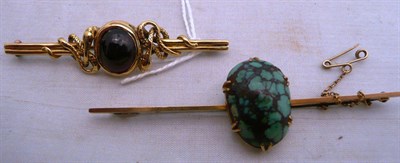 Lot 408 - A carbuncle garnet brooch and a turquoise matrix brooch