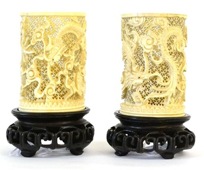 Lot 104 - A Pair of Chinese Ivory Sleeve Vases, late 19th century, carved and pierced with dragons...