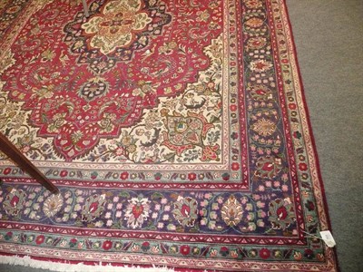 Lot 568 - A Tabriz red ground carpet