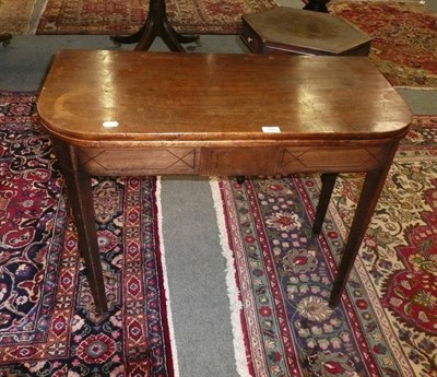 Lot 569 - Late George III mahogany fold over tea table