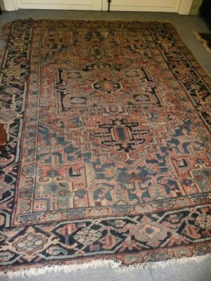 Lot 573 - Heriz Carpet, Persian Azerbaijan, the madder field centred by a cruciform medallion framed by ivory