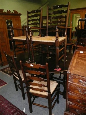 Lot 587 - Oak oval dining table and six chairs (two carvers and four dining chairs)