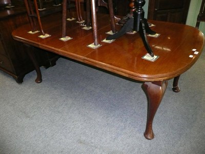 Lot 592 - Walnut extending dining table on cabriole legs