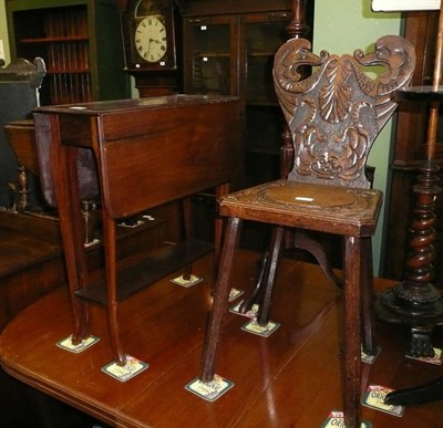 Lot 594 - Carved oak chair and a walnut Sutherland table