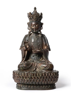 Lot 122 - A Chinese Bronze Figure of Buddha, probably Ming Dynasty, the cross-legged figure with scroll...